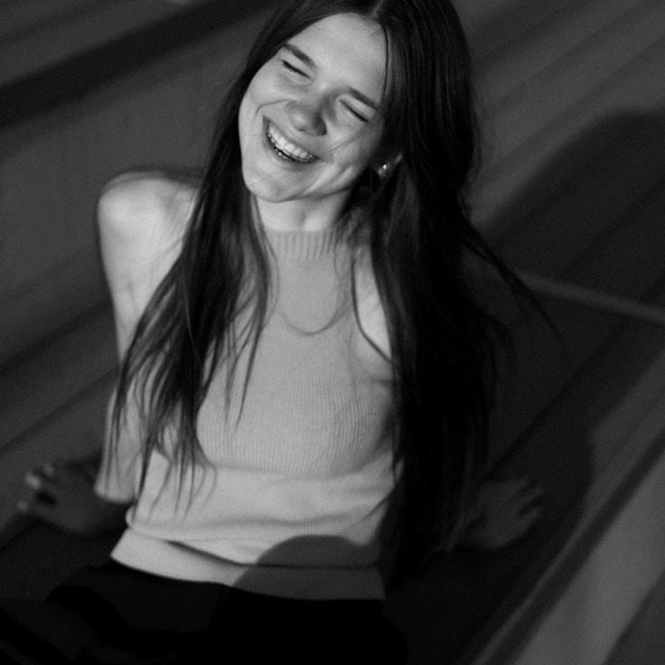 Avery Lane, Lead Design Curator at LanternTorchRivet, reviewing corporate floral arrangements